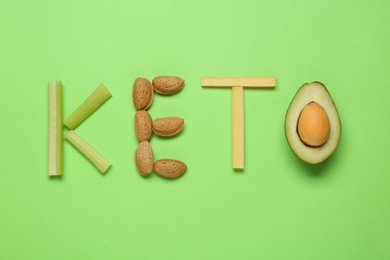 Photo of Word Keto made with different products on light green background, flat lay