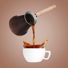 Pouring freshly brewed aromatic coffee from turkish pot into cup. Objects in air on dark beige background