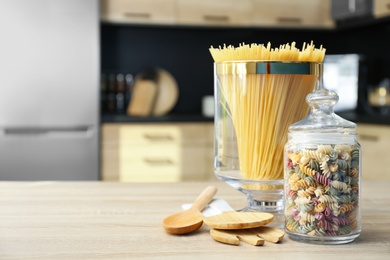 Products on wooden table in modern kitchen. Space for text