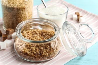 Photo of Various bowls with different sorts of sugar on table