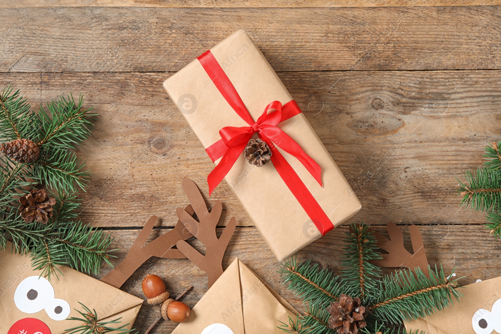 Photo of Flat lay composition with Christmas gift box on wooden table