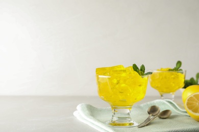 Dessert bowl with tasty jelly cubes served on table. Space for text