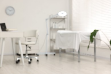 Blurred view of dermatologist's office with examination table