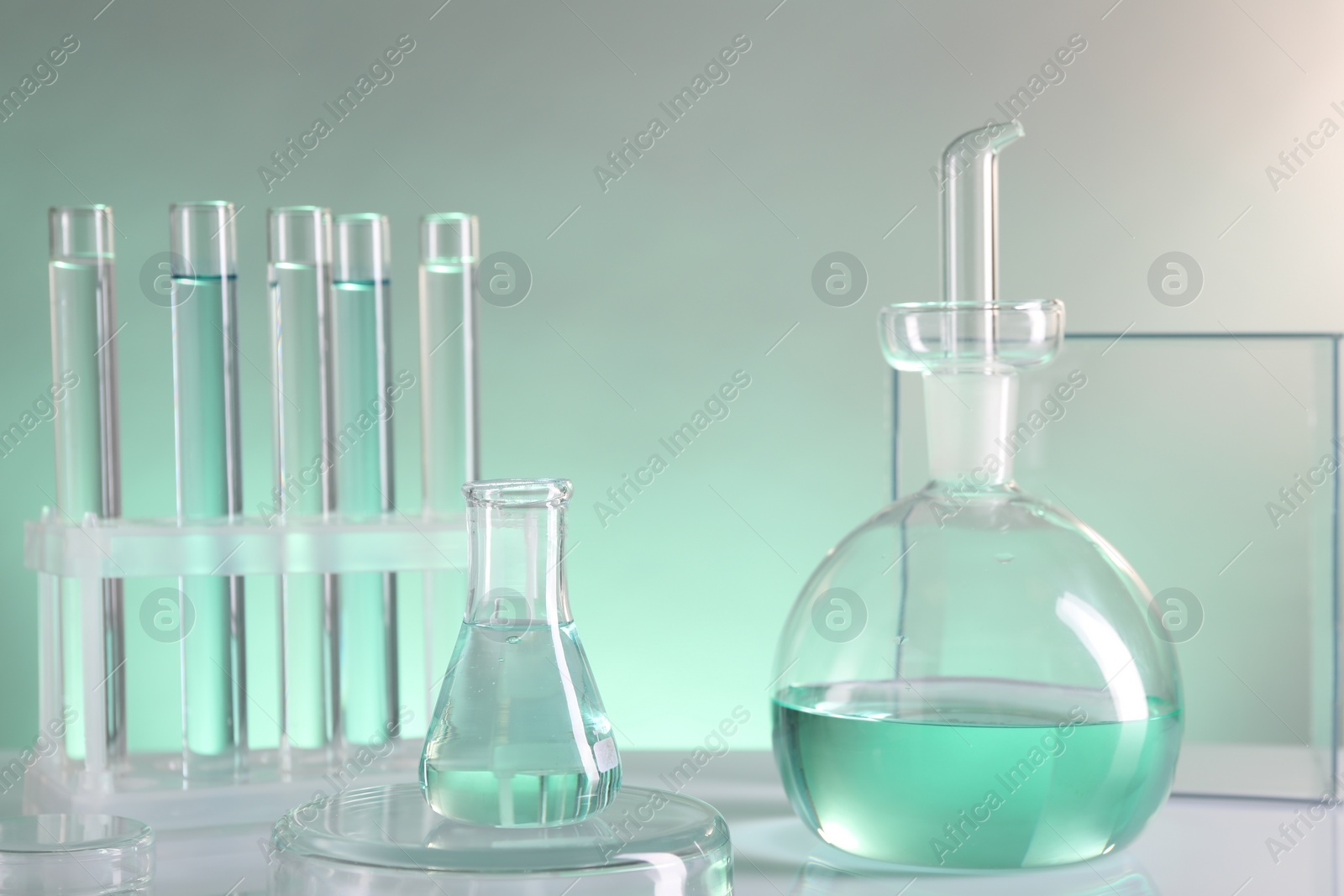 Photo of Laboratory analysis. Different glassware on table against color background