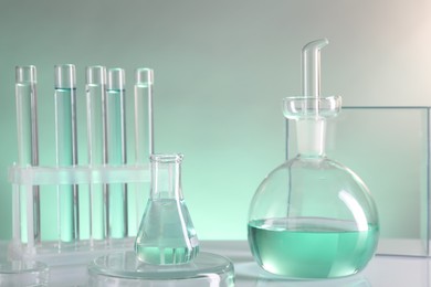 Photo of Laboratory analysis. Different glassware on table against color background