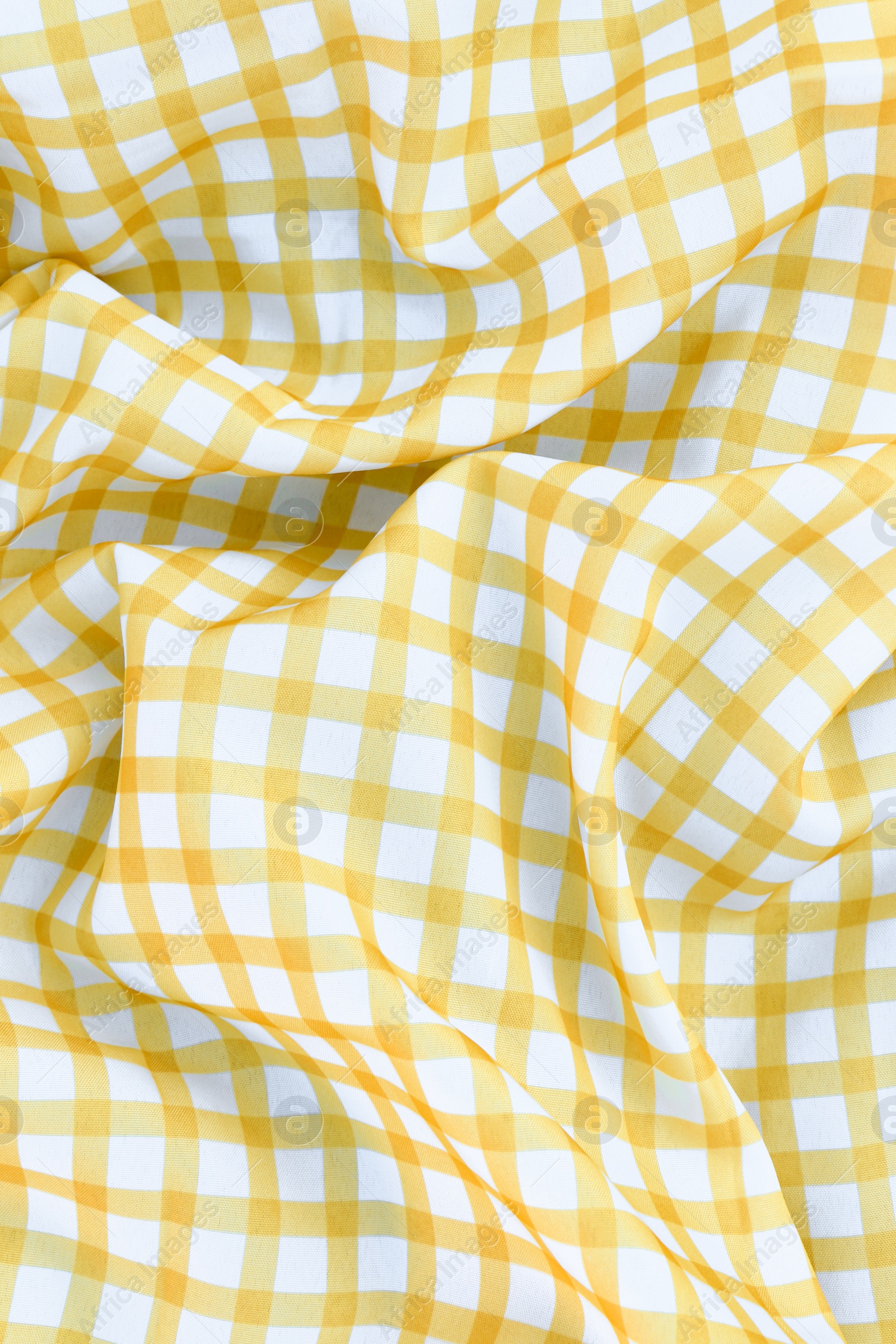 Photo of Yellow checkered picnic tablecloth as background, top view