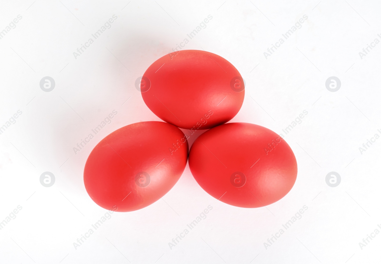 Photo of Red dyed Easter egg on white background, top view