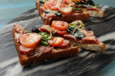 Tasty pizza toasts on table, closeup view