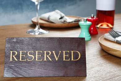 Photo of Table setting with RESERVED sign in restaurant