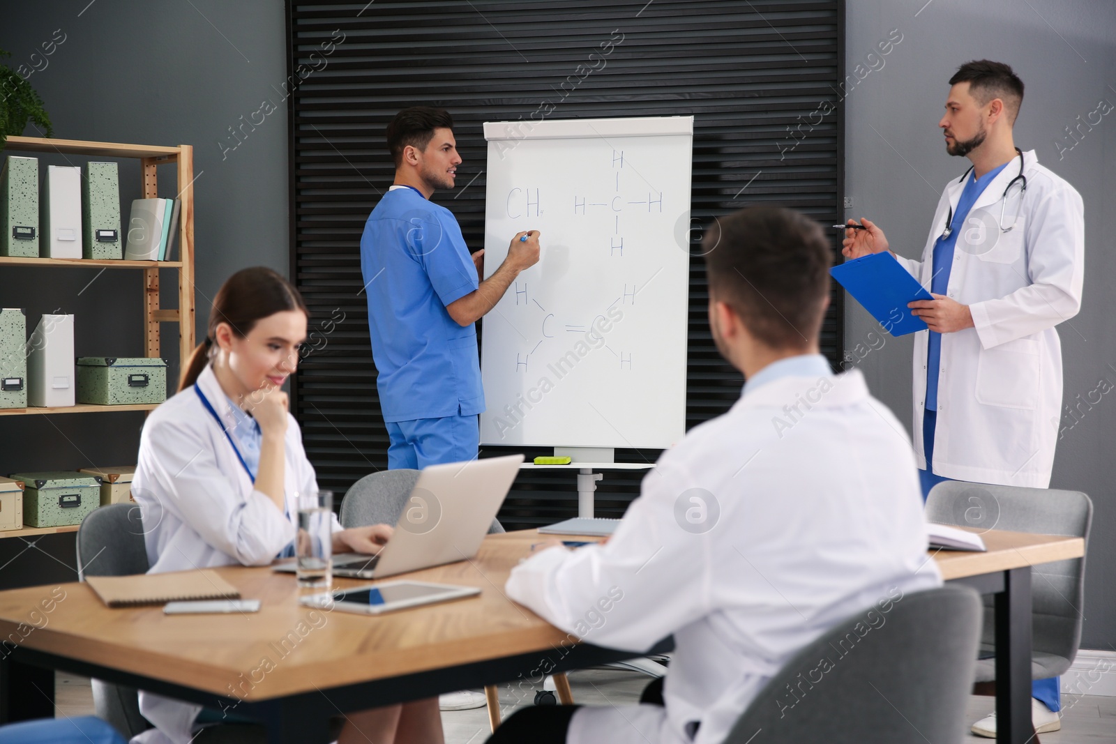 Photo of Team of professional doctors having meeting in office