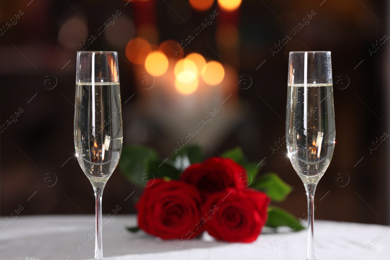 Photo of Glasses of champagne on table in restaurant. Romantic dinner