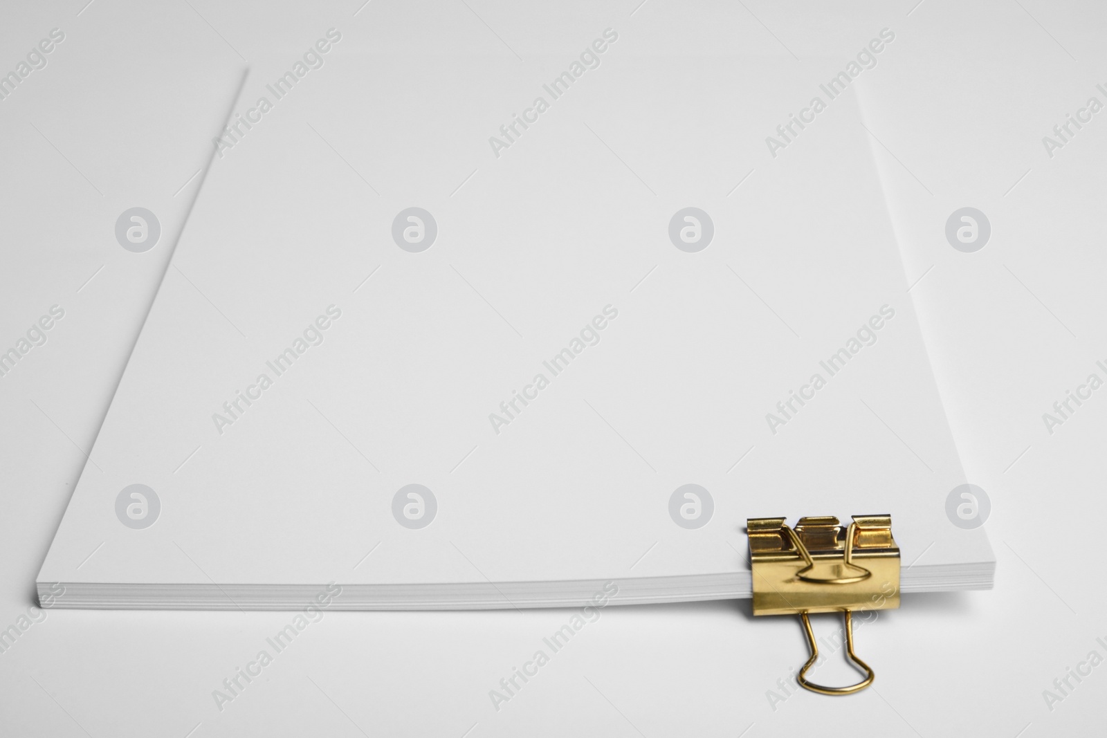 Photo of Sheets of paper with clip on white background