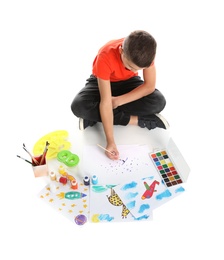 Photo of Cute child painting picture on white background