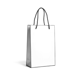 Photo of Paper shopping bag with handles on white background. Mockup for design