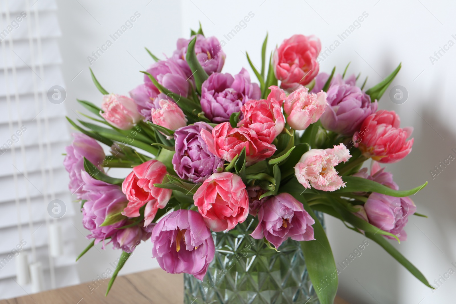 Photo of Beautiful bouquet of colorful tulip flowers indoors, closeup