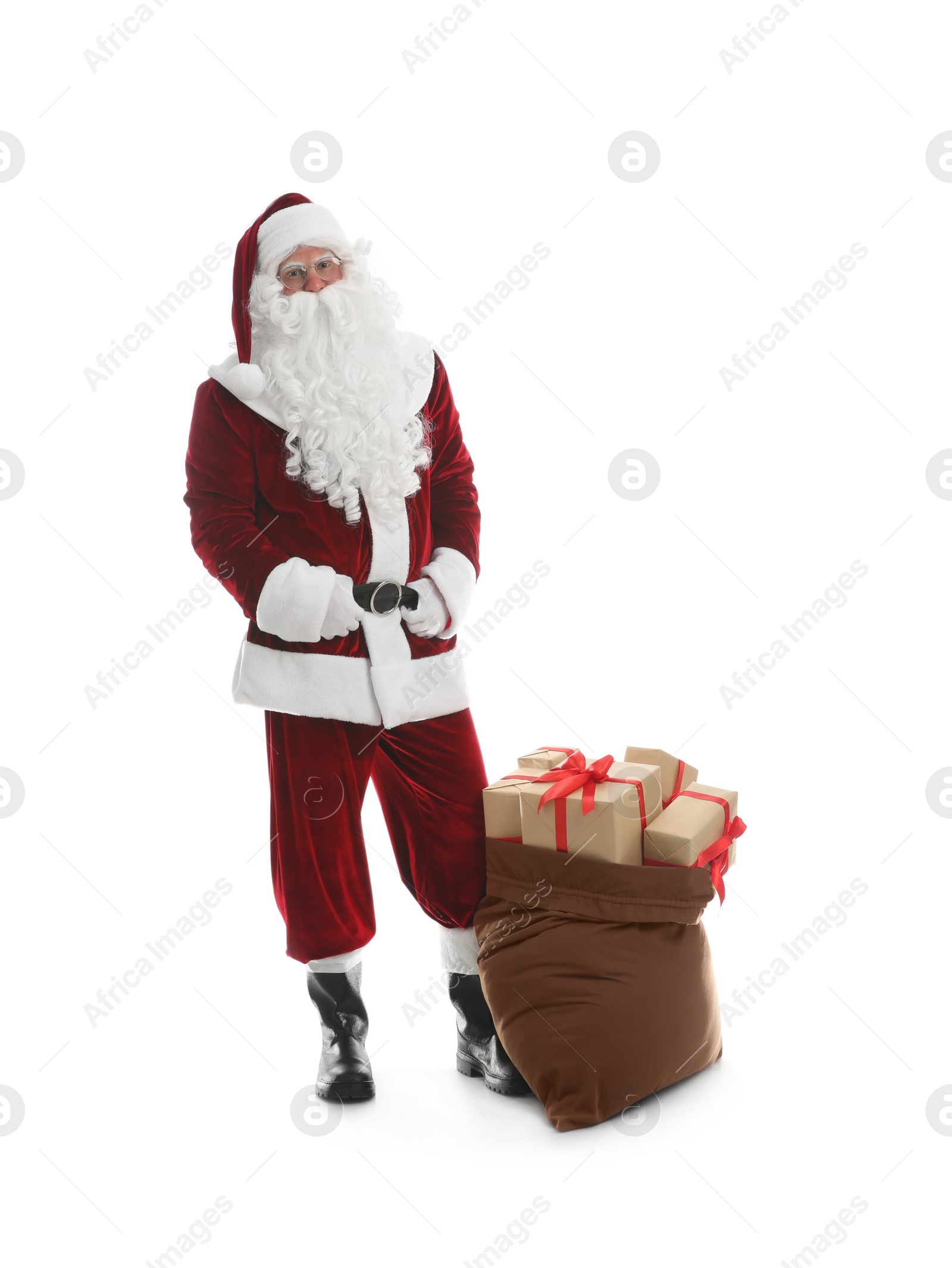 Photo of Santa Claus near sack of gifts on white background