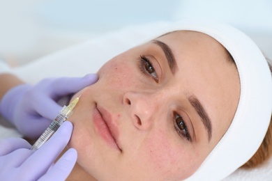 Photo of Woman undergoing face biorevitalization procedure in salon, closeup. Cosmetic treatment