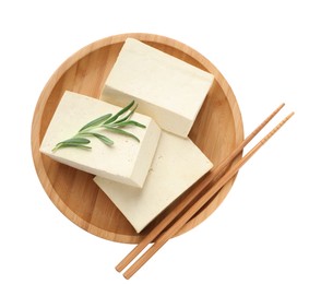 Photo of Wooden plate with delicious raw tofu, rosemary and chopsticks on white background, top view