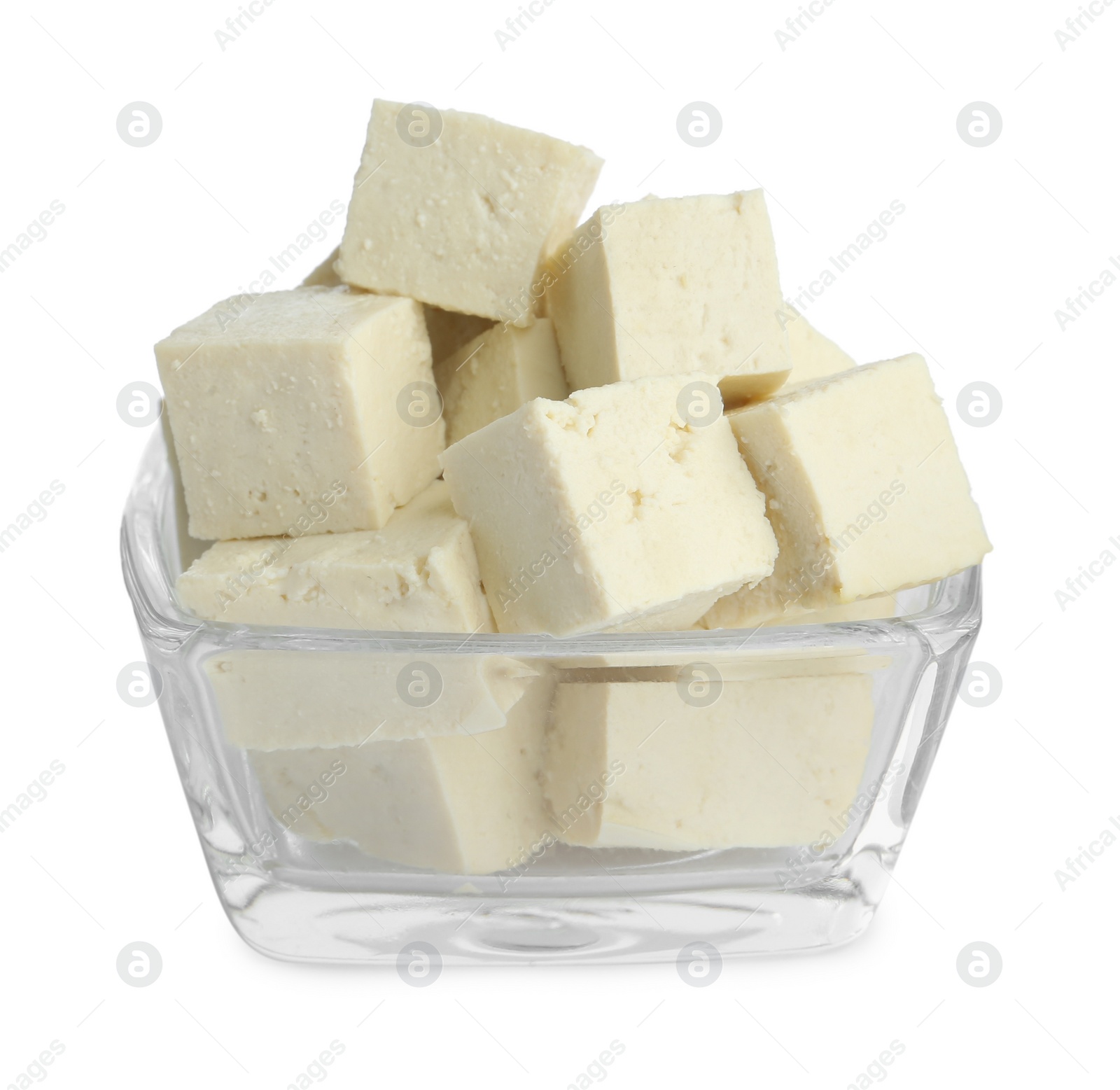 Photo of Pieces of delicious tofu in glass bowl on white background. Soybean curd