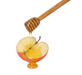 Photo of Pouring tasty honey onto cut apple on white background
