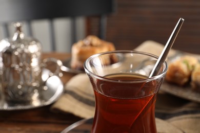 Traditional Turkish tea in glass on table, closeup. Space for text