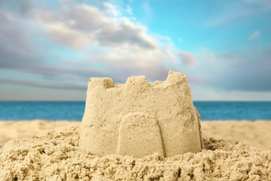 Image of Sand castle on ocean beach, closeup. Outdoor play