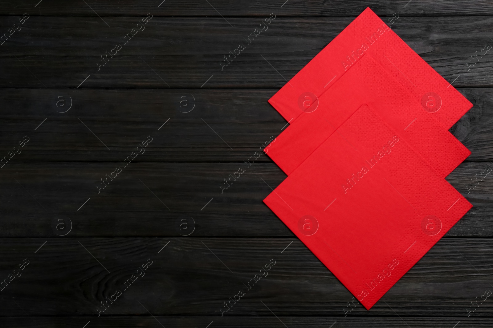 Photo of Clean napkins on wooden table, flat lay. Space for text