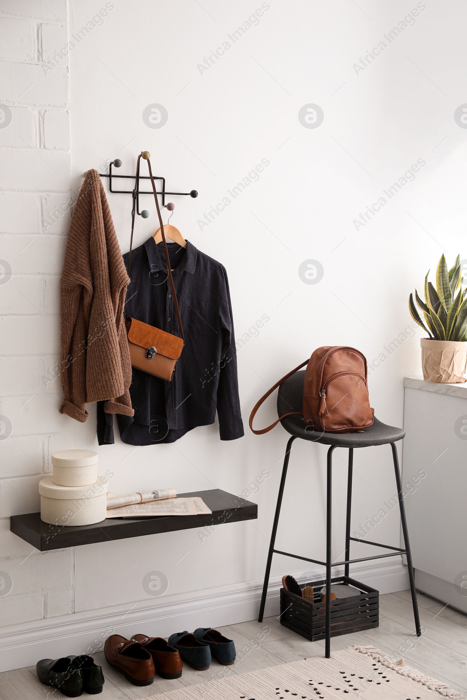 Photo of Hallway interior with stylish furniture, clothes and accessories