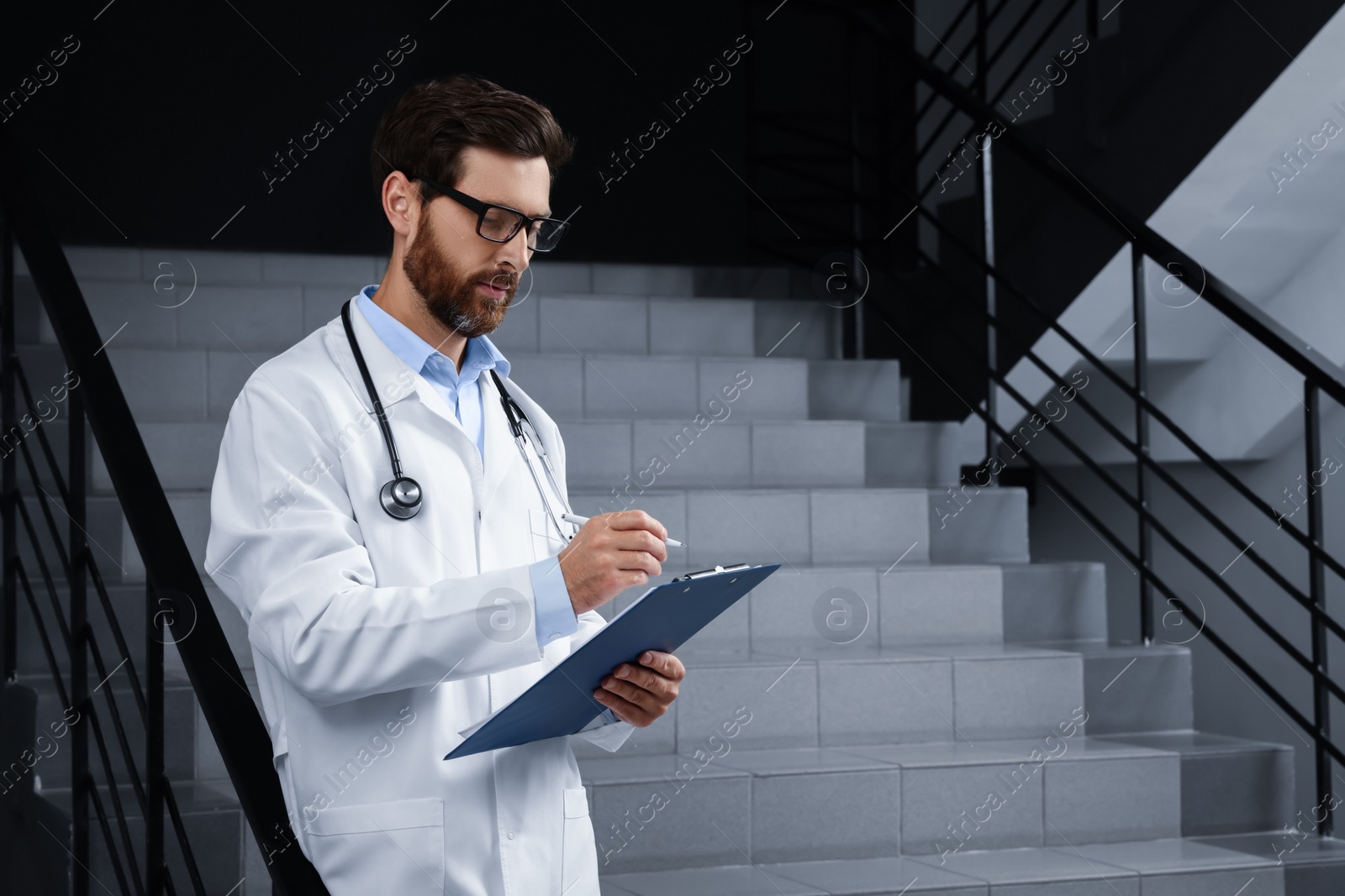 Photo of Doctor with stethoscope and clipboard in hospital
