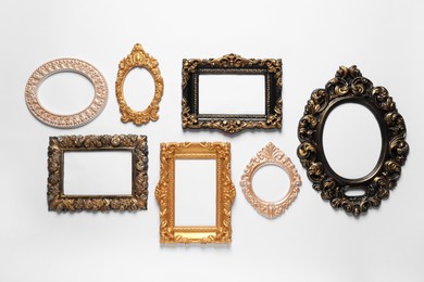 Photo of Blank vintage frames hanging on white wall