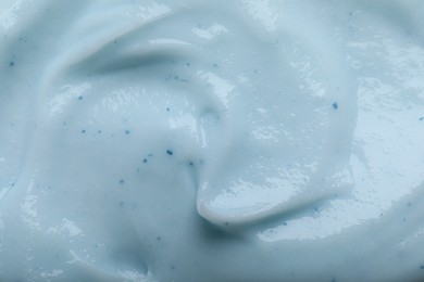 Closeup view of light blue body cream as background