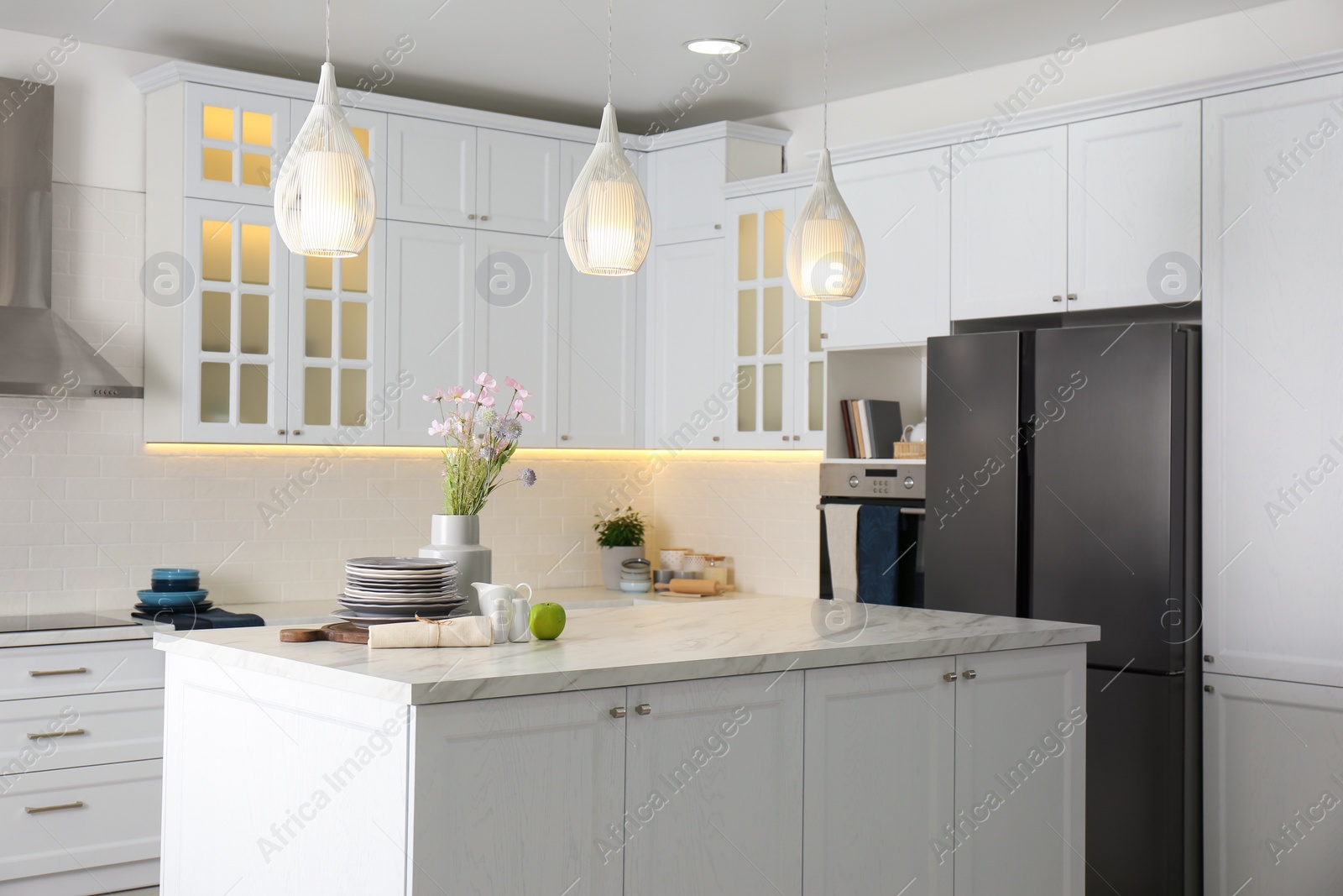 Photo of Modern kitchen interior with stylish white furniture