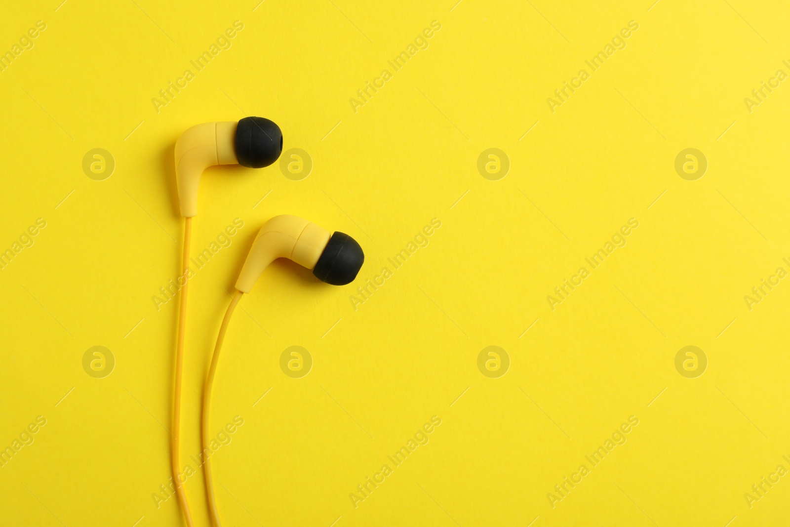 Photo of Stylish headphones on color background, top view. Space for text