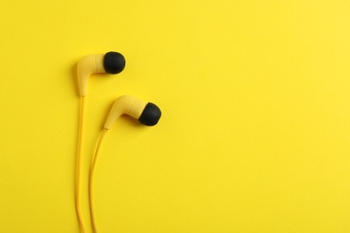 Photo of Stylish headphones on color background, top view. Space for text