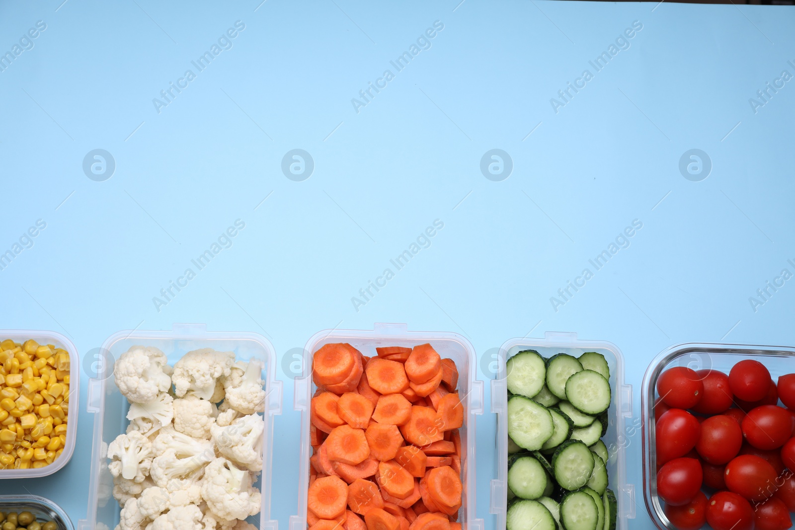 Photo of Plastic and glass containers with different fresh products on light blue background, flat lay. Space for text