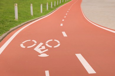 Red bike lane with painted white bicycle sign