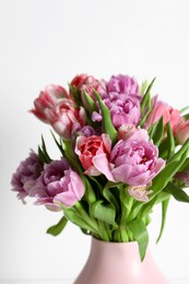 Photo of Beautiful bouquet of colorful tulip flowers on white background, closeup