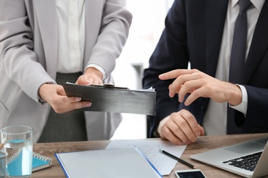 Young consultant working with client in office