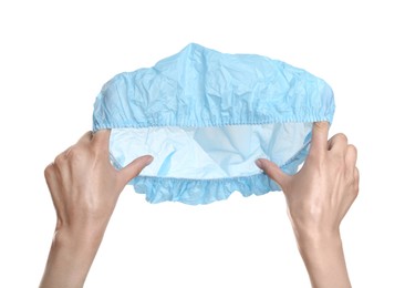 Photo of Woman holding light blue shower cap on white background, closeup
