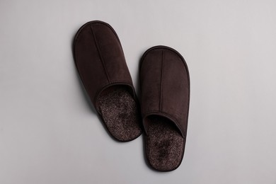 Photo of Pair of brown slippers on light grey background, top view