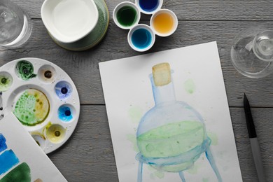 Photo of Flat lay composition with watercolor painting of flask and brush on grey wooden table