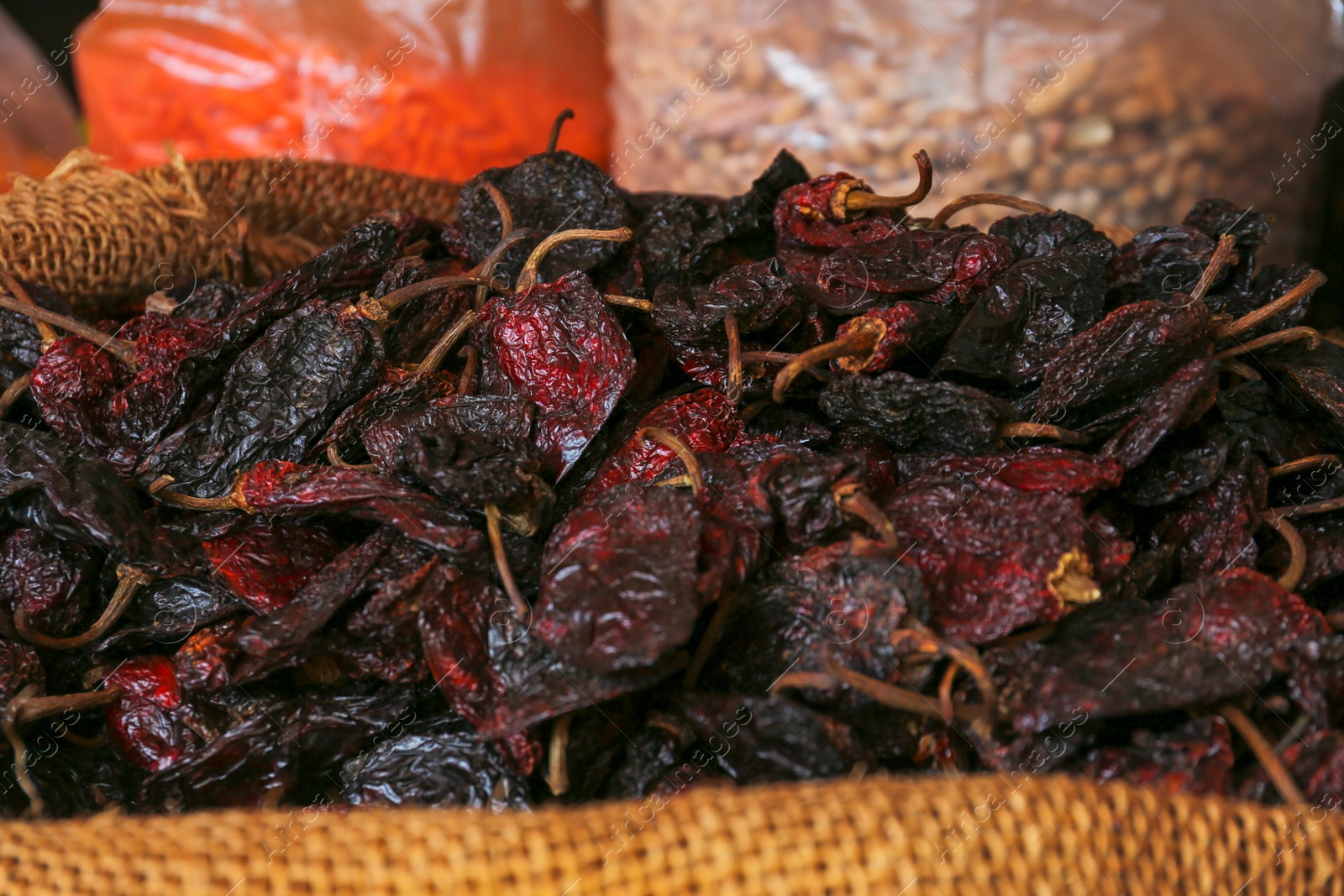 Photo of Heap of Ancho chile peppers on counter at market, closeup