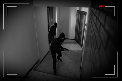 Image of Dangerous criminals in masks with weapon in hallway, view through CCTV camera