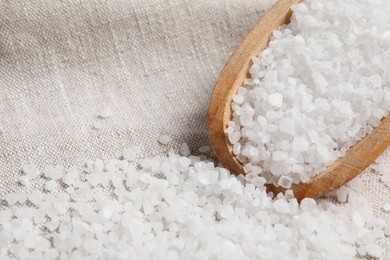 Photo of Scoop of natural sea salt on cloth, closeup. Space for text
