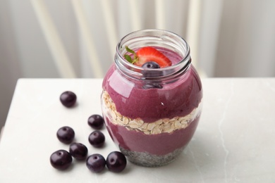 Photo of Jar of tasty acai smoothie on light table