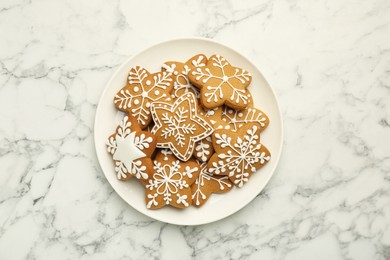 Tasty star shaped Christmas cookies with icing on white marble table, top view