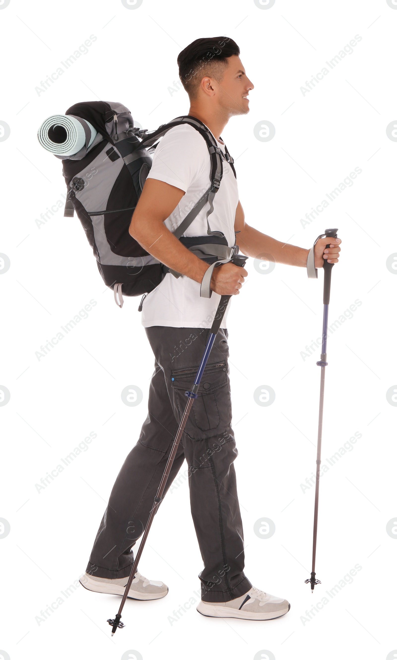 Photo of Male hiker with backpack and trekking poles on white background