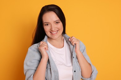 Photo of Beautiful overweight woman with charming smile on yellow background