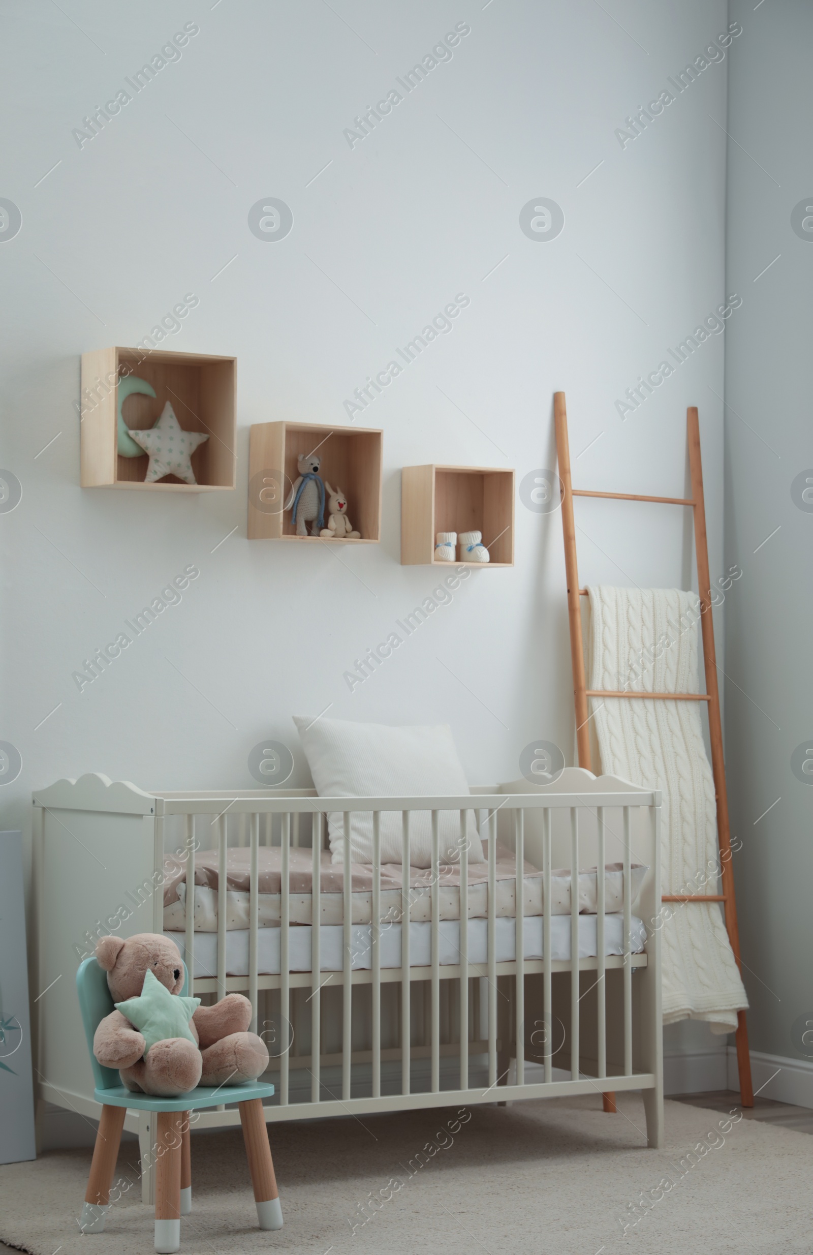 Photo of Stylish baby room interior with crib and toys