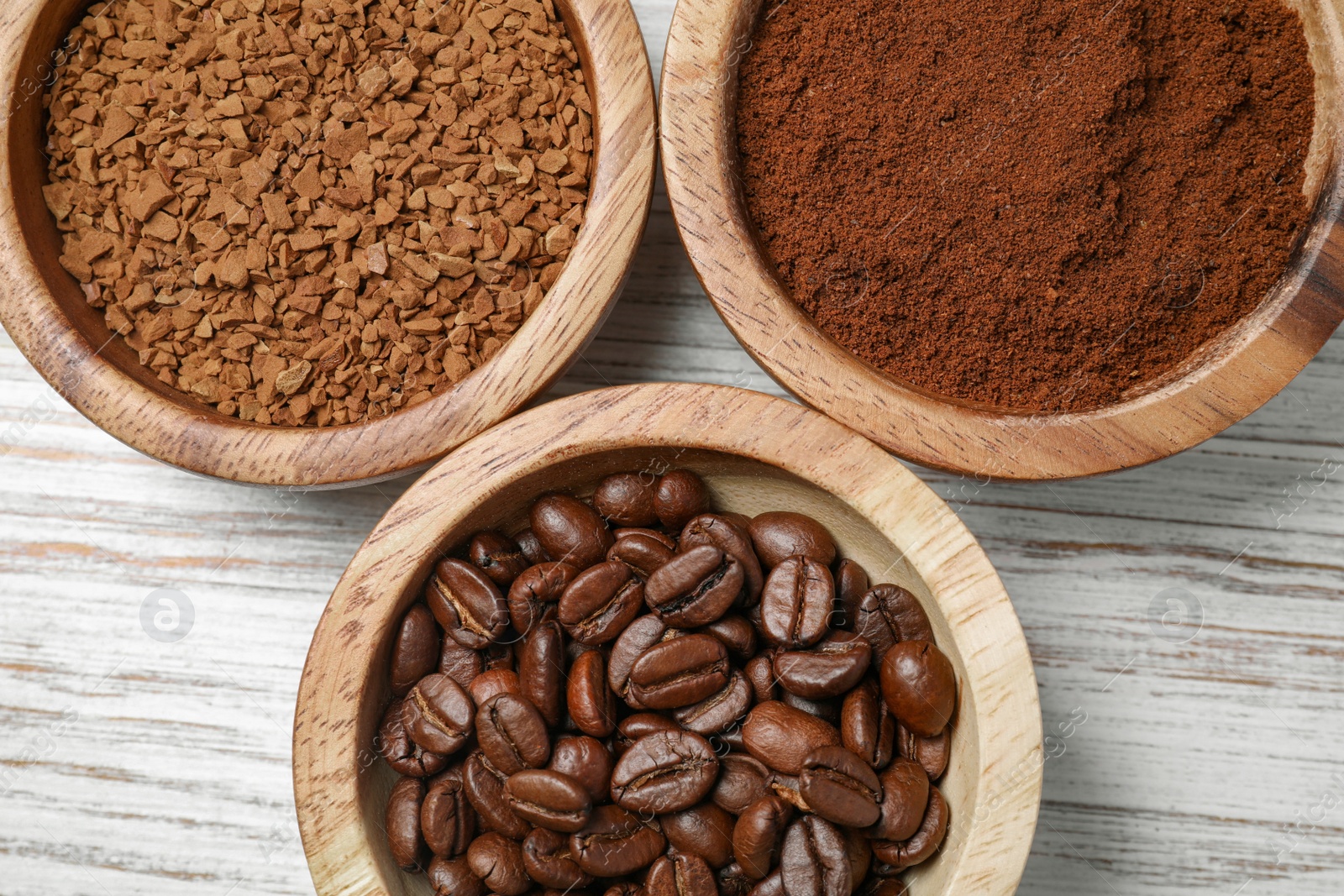 Photo of Instant, ground coffee and roasted beans on white wooden table, flat lay